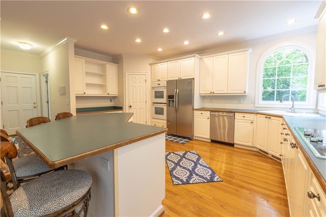 54 Old Fuller Mill Road Ne, Marietta, GA 30067 - kitchen with white cabinets, a breakfast bar area, stainless steel appliances, and light wood-type flooring