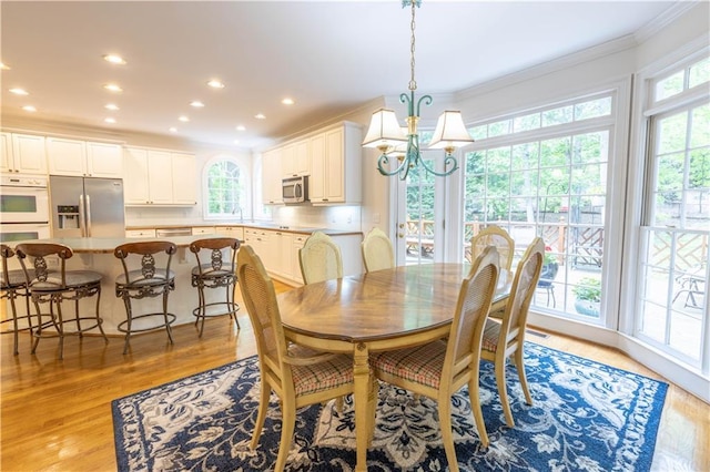 54 Old Fuller Mill Road Ne, Marietta, GA 30067 - dining area featuring sink, a notable chandelier, ornamental molding, and light hardwood / wood-style floors