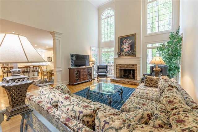 54 Old Fuller Mill Road Ne, Marietta, GA 30067 - living room featuring plenty of natural light, ornate columns, a fireplace, and light hardwood / wood-style flooring
