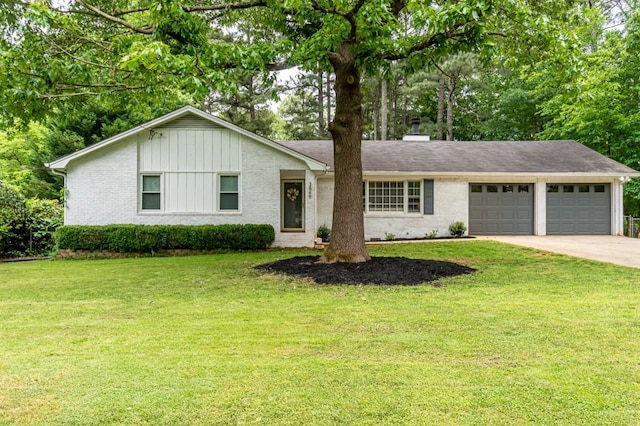 single story home featuring a front lawn and a garage