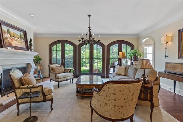 sitting room featuring an inviting chandelier, french doors, hardwood / wood-style floors, and plenty of natural light