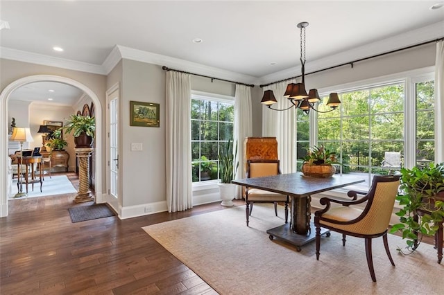 dining room featuring a chandelier, dark hardwood / wood-style floors, and ornamental molding