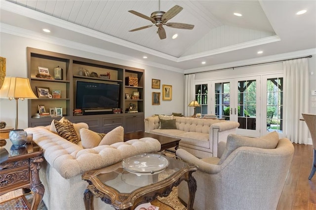 living room featuring ceiling fan, vaulted ceiling, hardwood / wood-style flooring, ornamental molding, and french doors