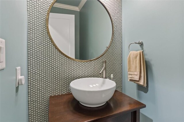 bathroom featuring vanity, crown molding, and tile walls