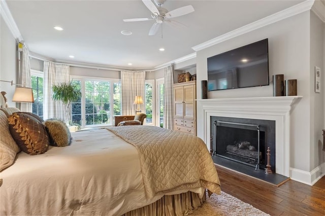 bedroom with ceiling fan, dark hardwood / wood-style floors, and crown molding