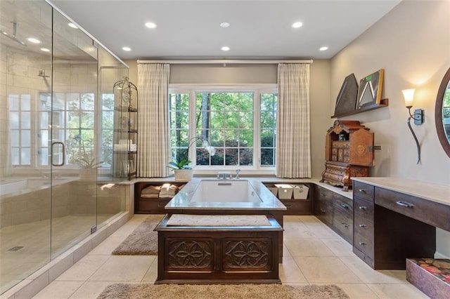 bathroom featuring shower with separate bathtub and tile floors