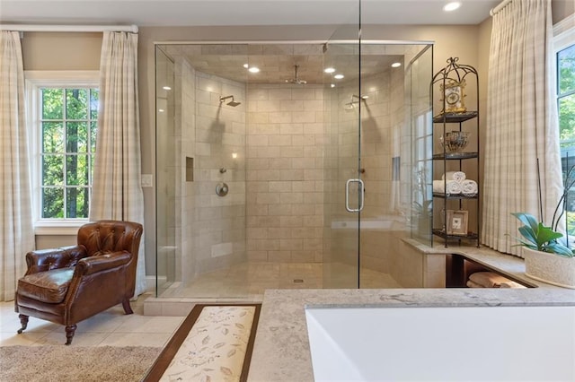 bathroom with a shower with shower door and tile floors