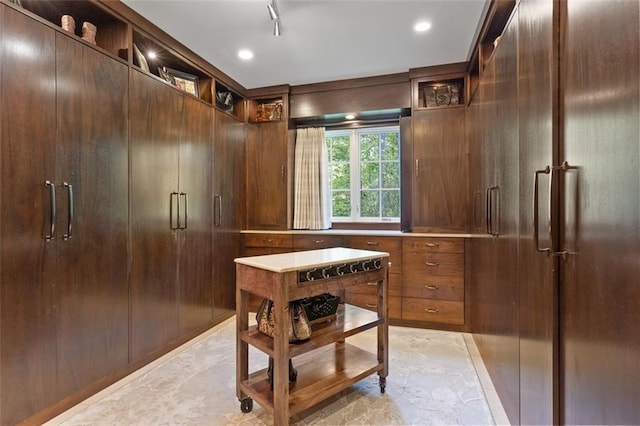 spacious closet with light tile floors