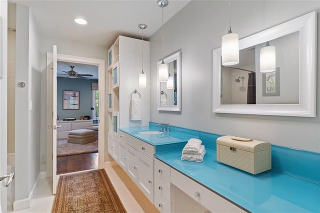 bathroom with hardwood / wood-style floors, vanity, and ceiling fan