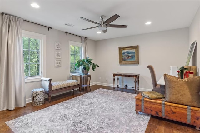 sitting room with dark hardwood / wood-style flooring and ceiling fan