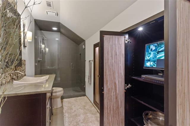 bathroom featuring vanity, a shower with door, tile floors, and toilet