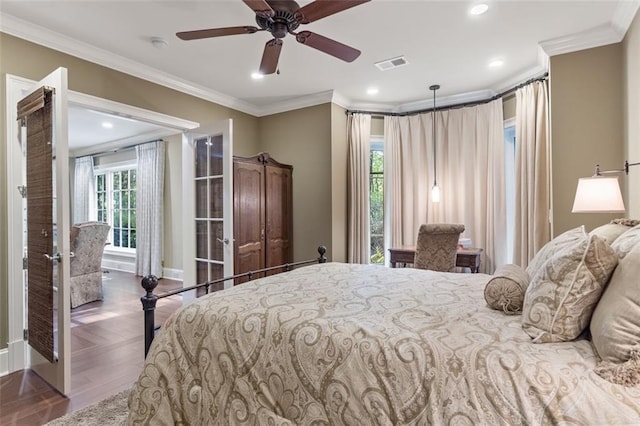 bedroom with dark hardwood / wood-style floors, ornamental molding, ceiling fan, and french doors