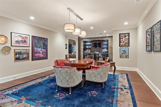 dining room with crown molding and dark hardwood / wood-style floors