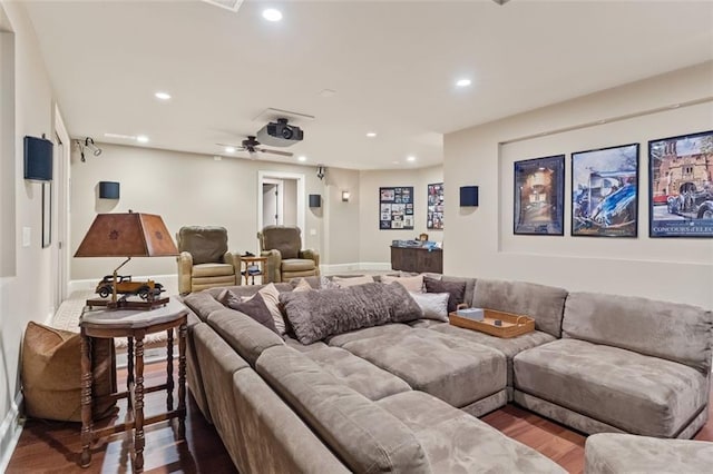 home theater room featuring ceiling fan and dark hardwood / wood-style floors