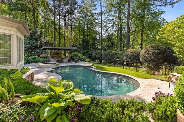 view of swimming pool featuring an in ground hot tub, a lawn, and a patio