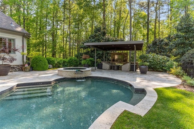 view of swimming pool with an in ground hot tub, an outdoor kitchen, and a patio