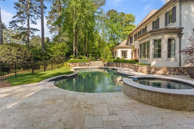 view of swimming pool with an in ground hot tub, a lawn, and a patio