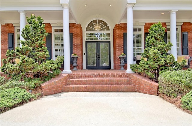 entrance to property with covered porch and french doors