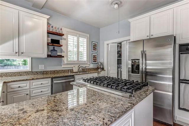 3248 W Shadowlawn Avenue Ne, Atlanta, GA 30305 - kitchen featuring light stone countertops, white cabinetry, and stainless steel appliances