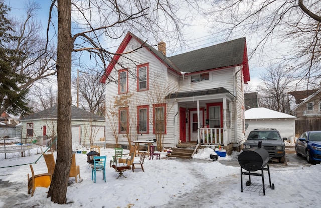 view of front facade featuring covered porch and a garage