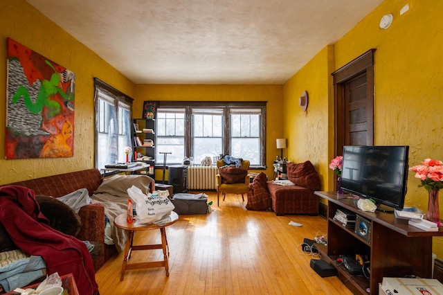 living room featuring radiator and light wood-type flooring