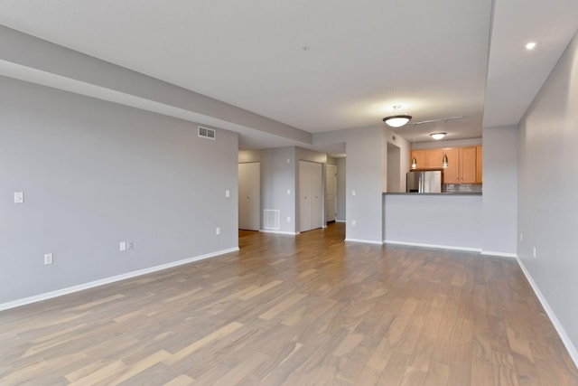 unfurnished living room featuring hardwood / wood-style flooring