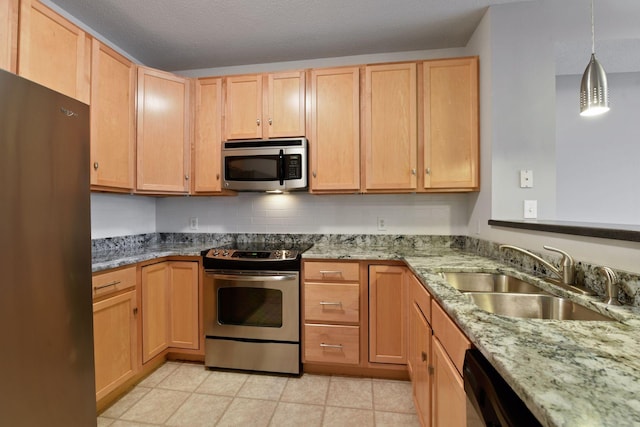 kitchen featuring light tile floors, stainless steel appliances, sink, light stone countertops, and hanging light fixtures