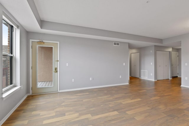 unfurnished room with dark wood-type flooring