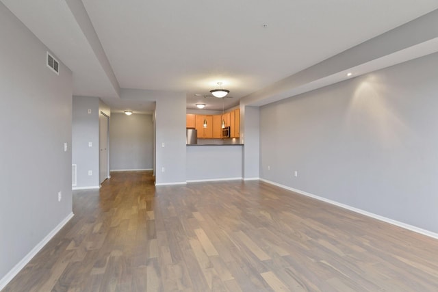 unfurnished living room with hardwood / wood-style flooring