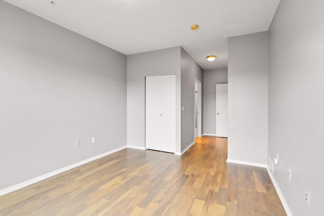 spare room with wood-type flooring