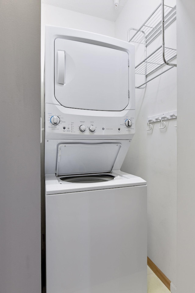 laundry area with stacked washer and dryer