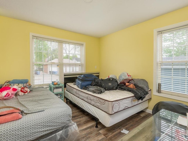 bedroom with dark hardwood / wood-style floors