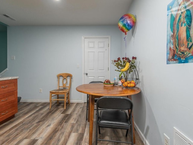 dining area with dark hardwood / wood-style flooring