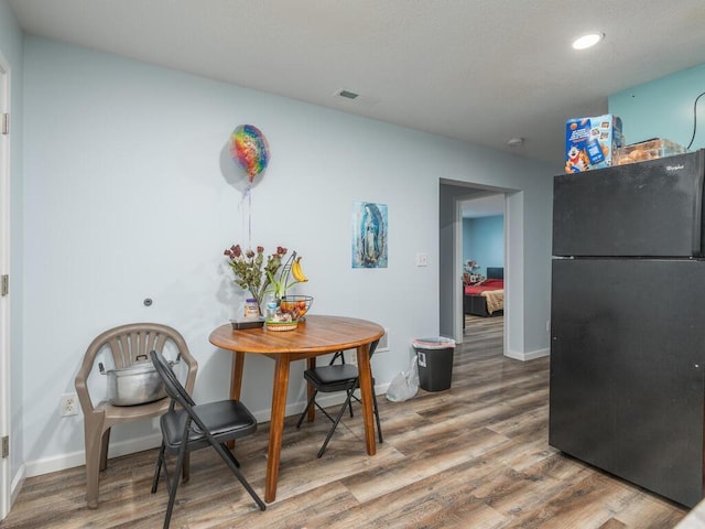 dining area with wood-type flooring