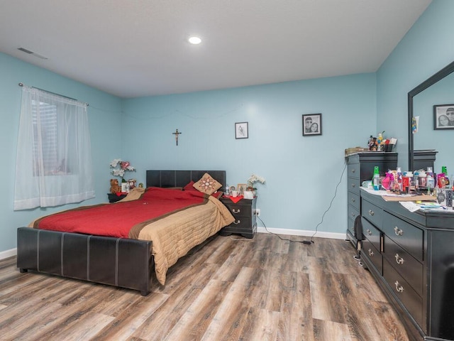 bedroom with wood-type flooring