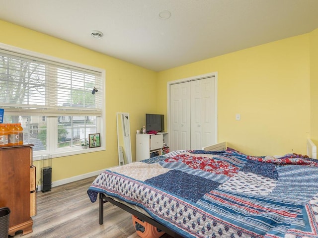 bedroom featuring light hardwood / wood-style floors and a closet