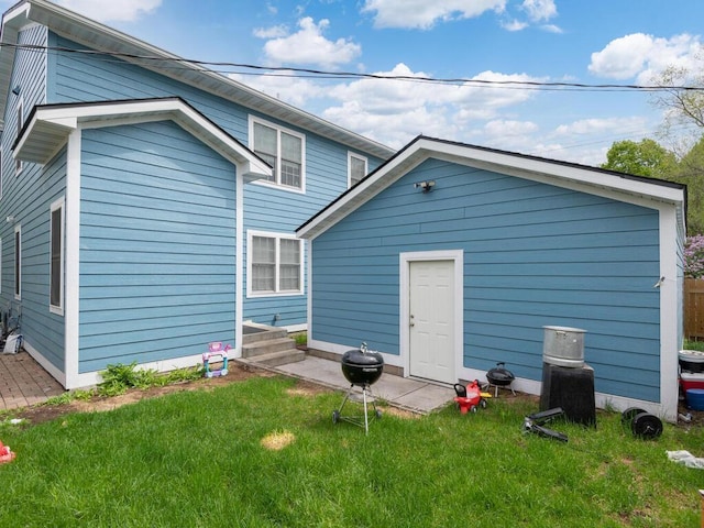 back of property featuring a lawn