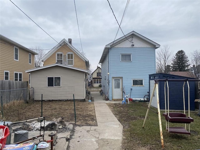 rear view of property with a trampoline