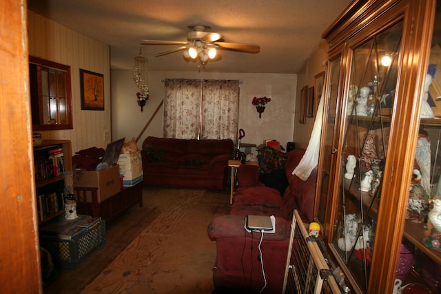 living room with ceiling fan and dark hardwood / wood-style floors