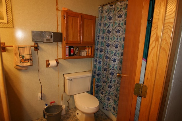 bathroom featuring toilet and tile floors