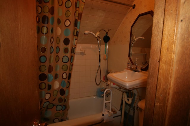 bathroom featuring shower / bath combo with shower curtain and sink