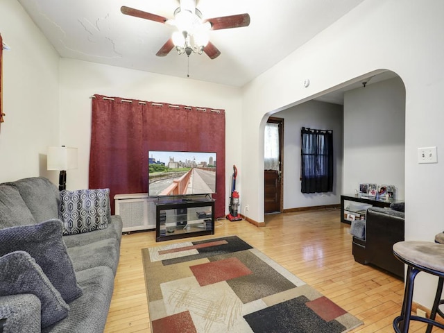 living room featuring ceiling fan and light wood-type flooring