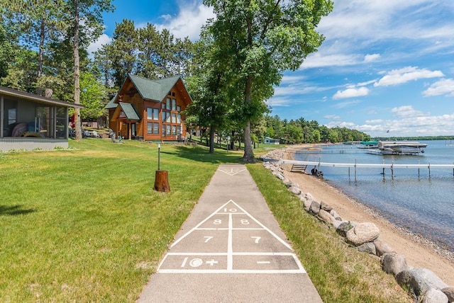 view of property's community featuring a water view and a yard