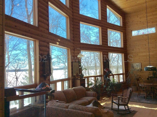 living room with wood ceiling and high vaulted ceiling