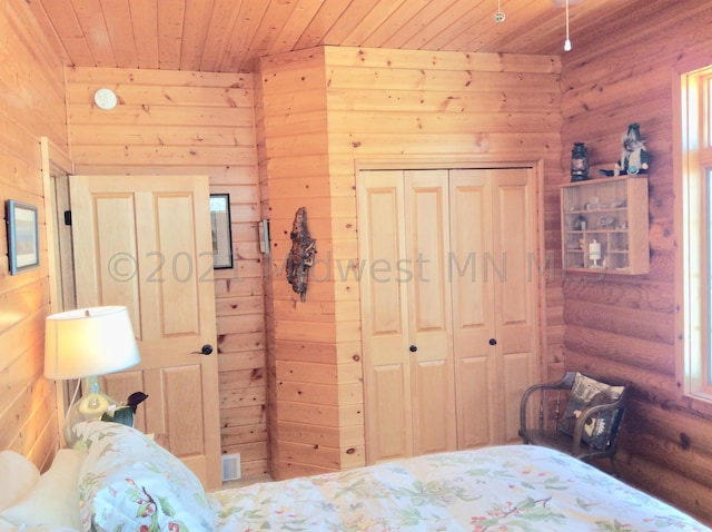 24557 Walden Rd, Rochert, MN 56578 - bedroom with wood ceiling, wood walls, a closet, and visible vents