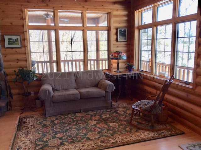 living room with wood-type flooring and rustic walls