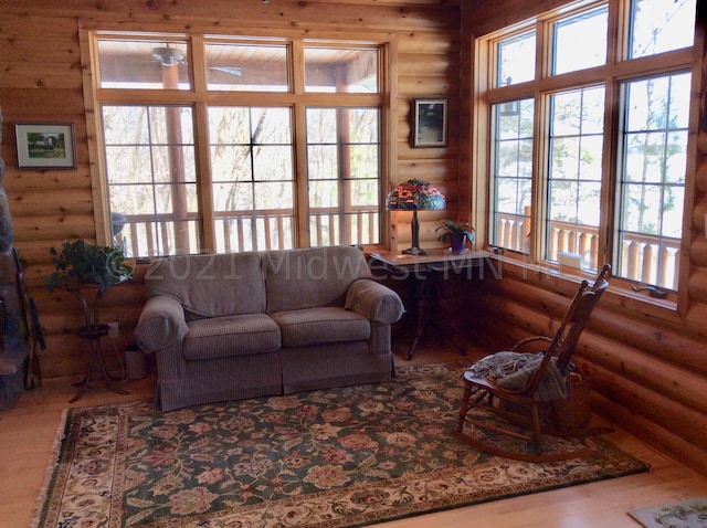 24557 Walden Rd, Rochert, MN 56578 - living area featuring rustic walls, wood finished floors, and a wealth of natural light
