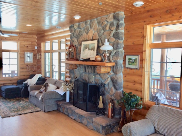 24557 Walden Rd, Rochert, MN 56578 - living room featuring rustic walls, wood finished floors, ceiling fan, wood ceiling, and a fireplace
