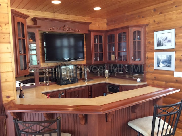 bar featuring wood ceiling and wooden walls