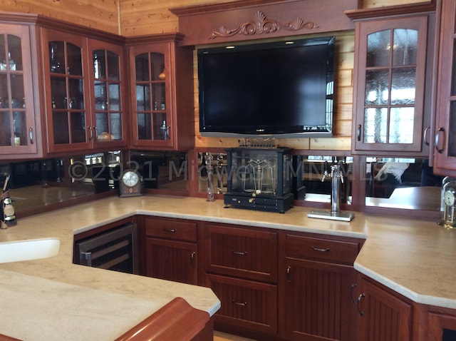 kitchen with wood walls, sink, and beverage cooler